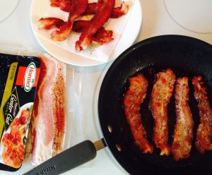 bacon being fried in pan