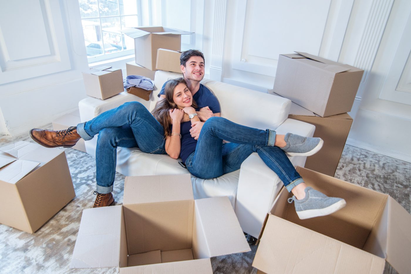 happy couple laying on couch