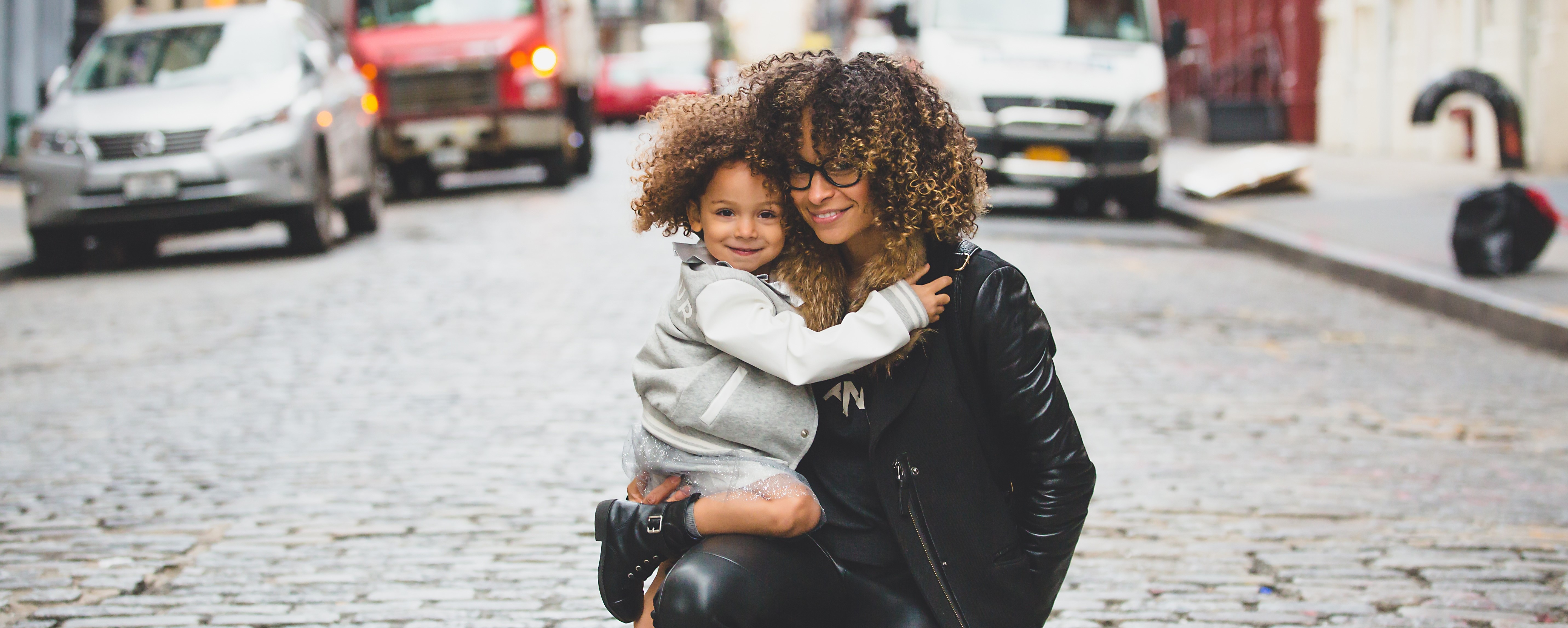 mom and child in the middle of the street in the city