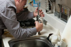 man checking plumbing