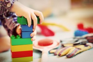 child playing with toy blocks