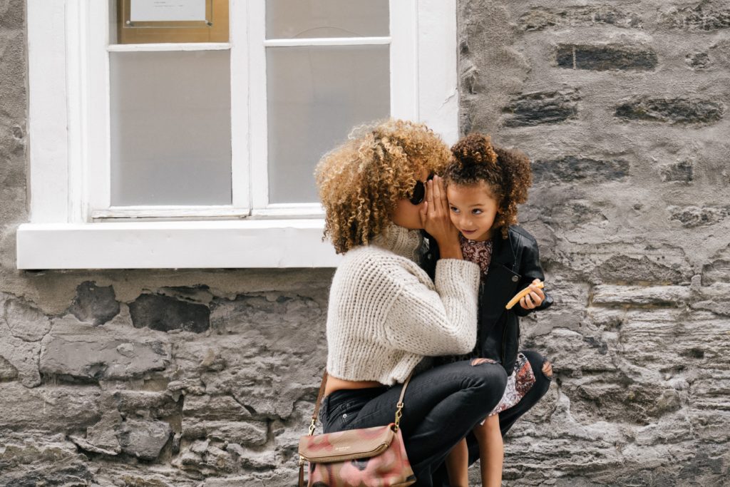 Woman Whispering to Child