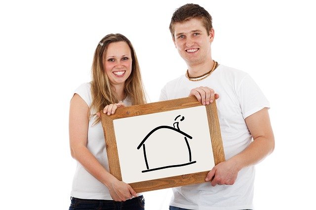 couple holding a drawing of a house