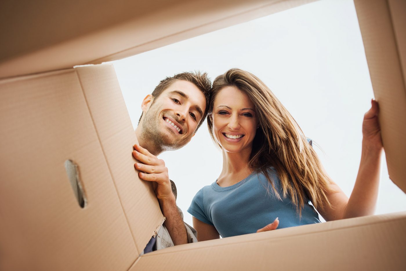 couple looking down into moving box