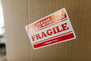 cardboard box with red label that says fragile