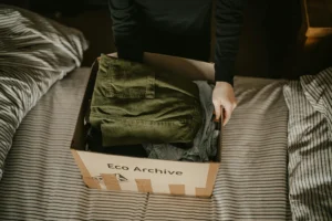 Man packing clothes in box